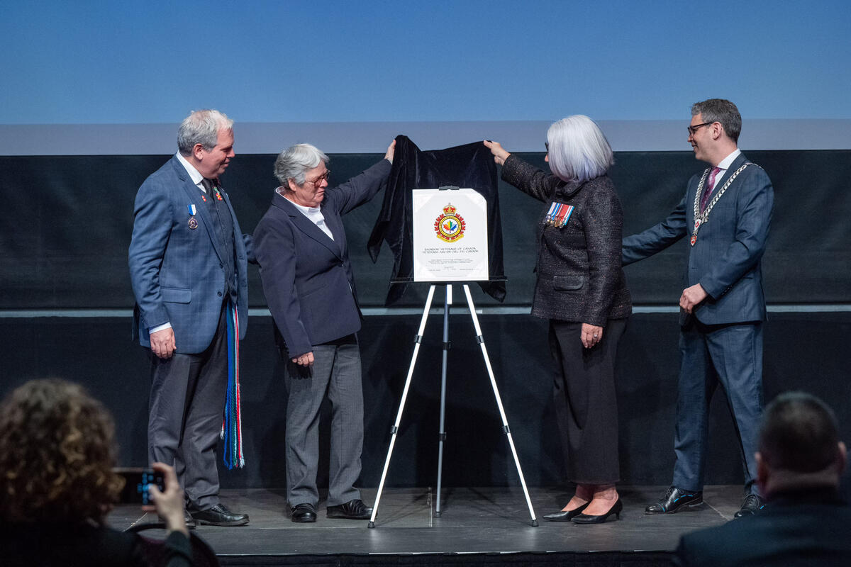 Governor General Mary Simon unveils the new Rainbow Veterans of Canada badge on stage