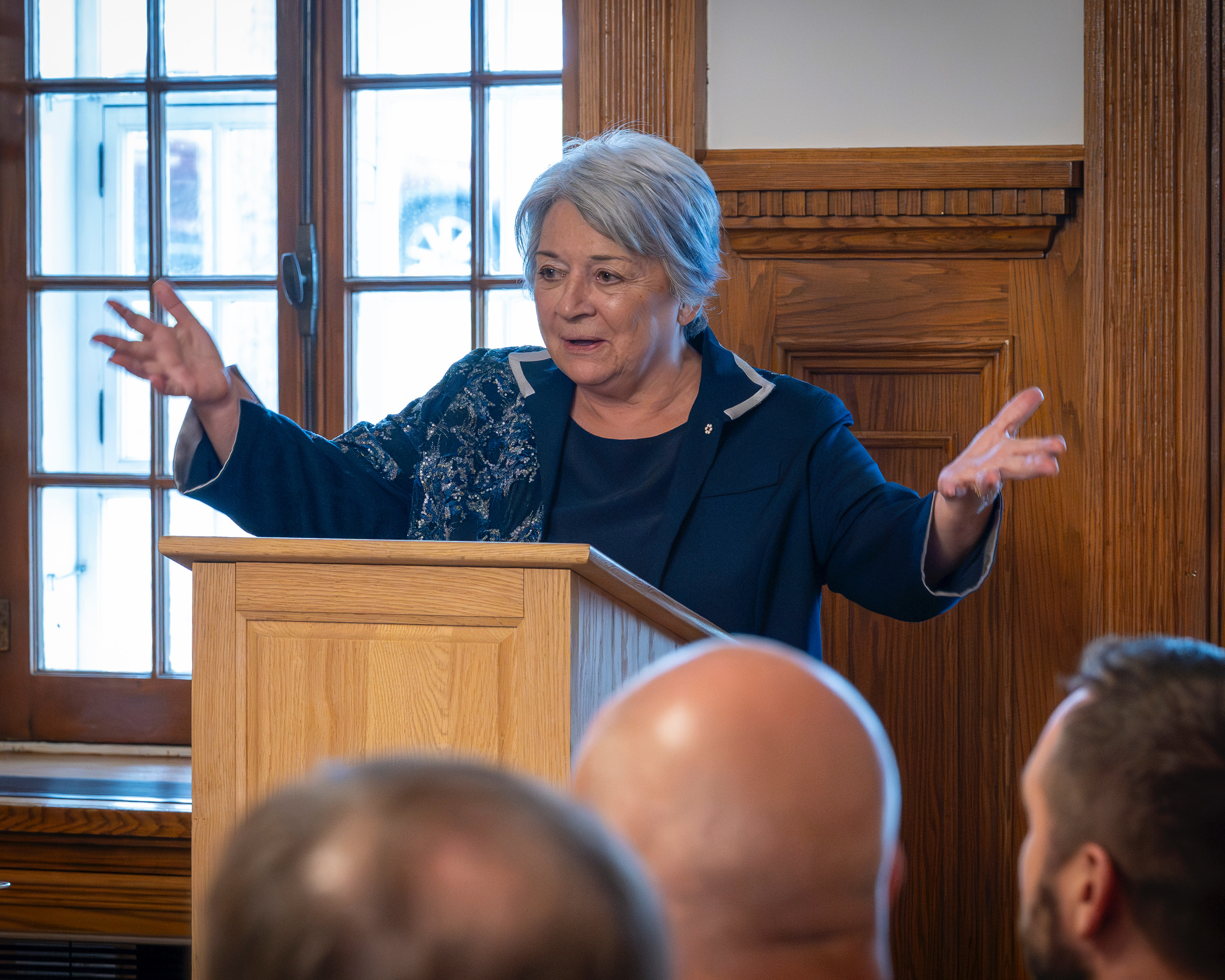 Governor General Mary Simon standing at a small podium addressing a group of people.