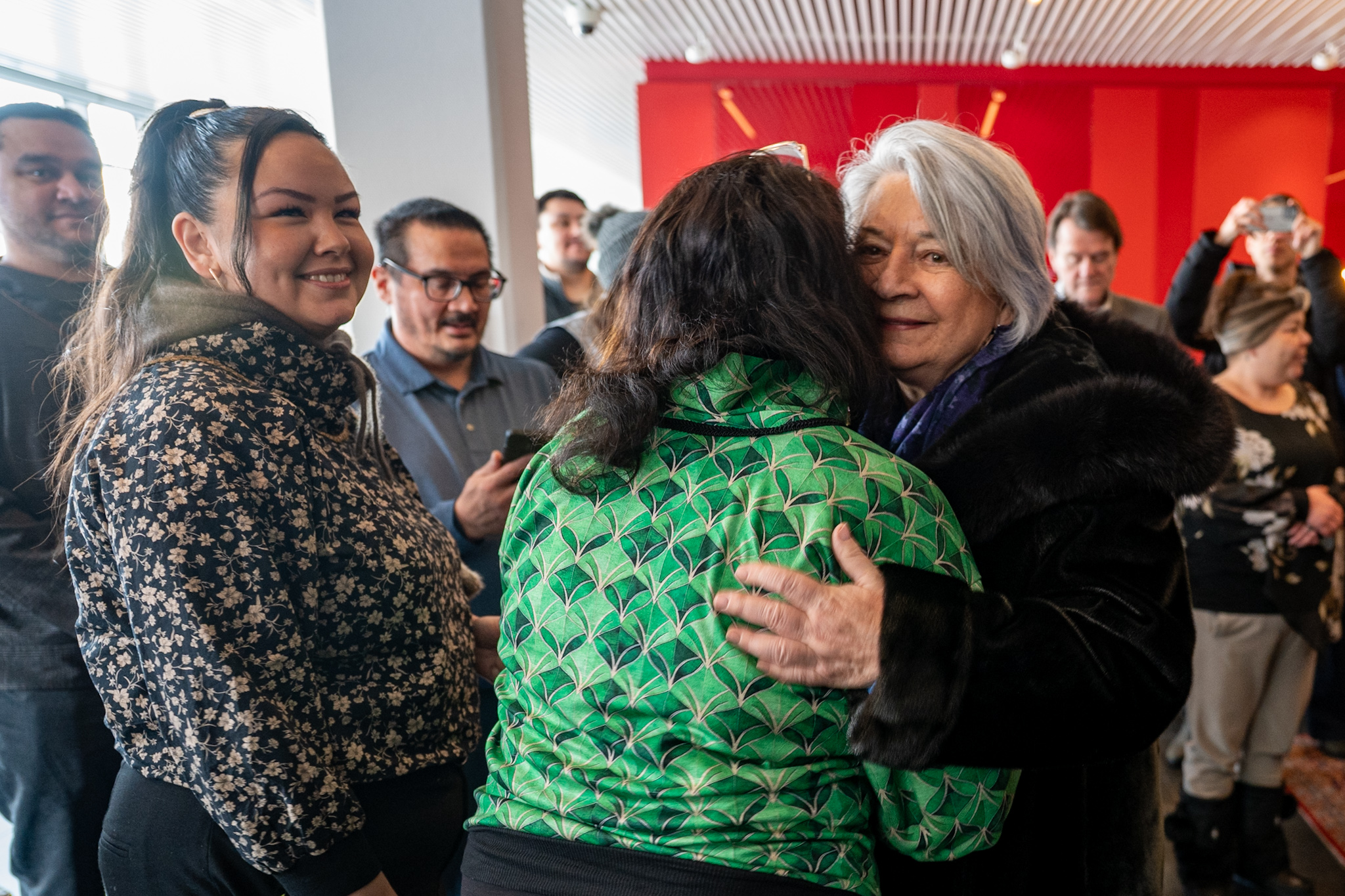 Governor General Mary Simon hugging someone in the crowd of people welcoming her in Greenland.