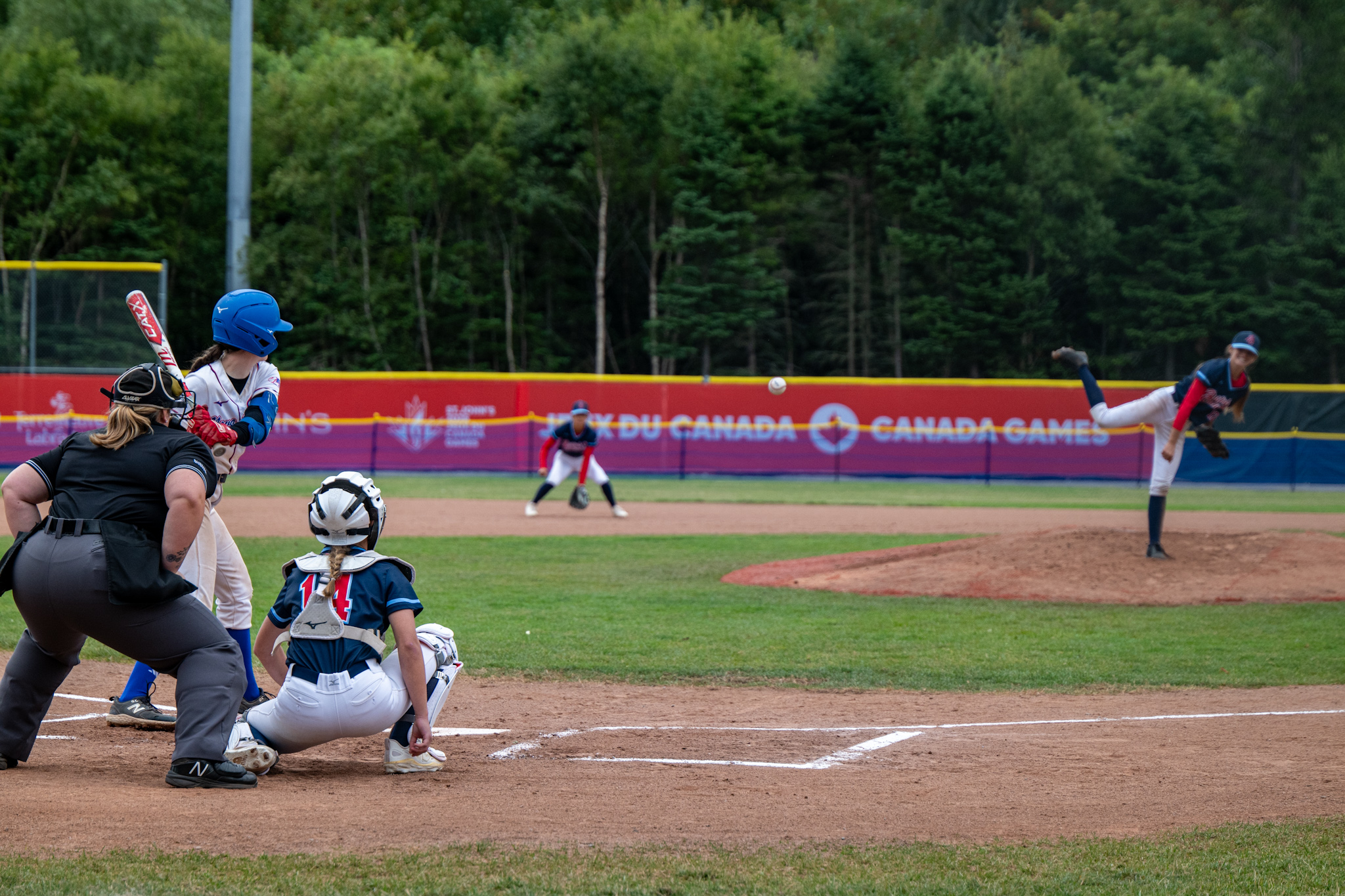 A pitcher who has just thrown a baseball at home plate.