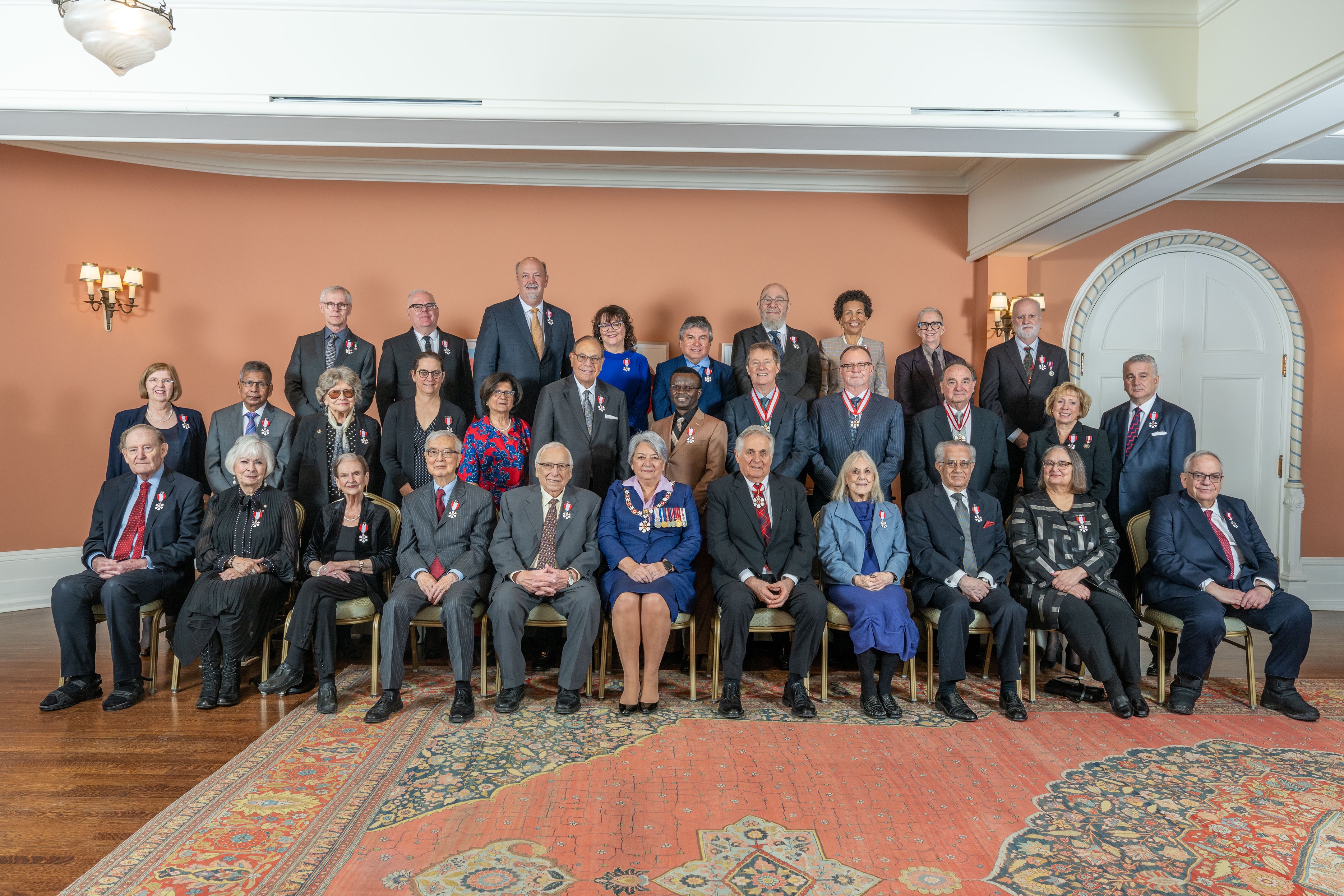 Governor General Mary Simon posing with Order of Canada recipients.