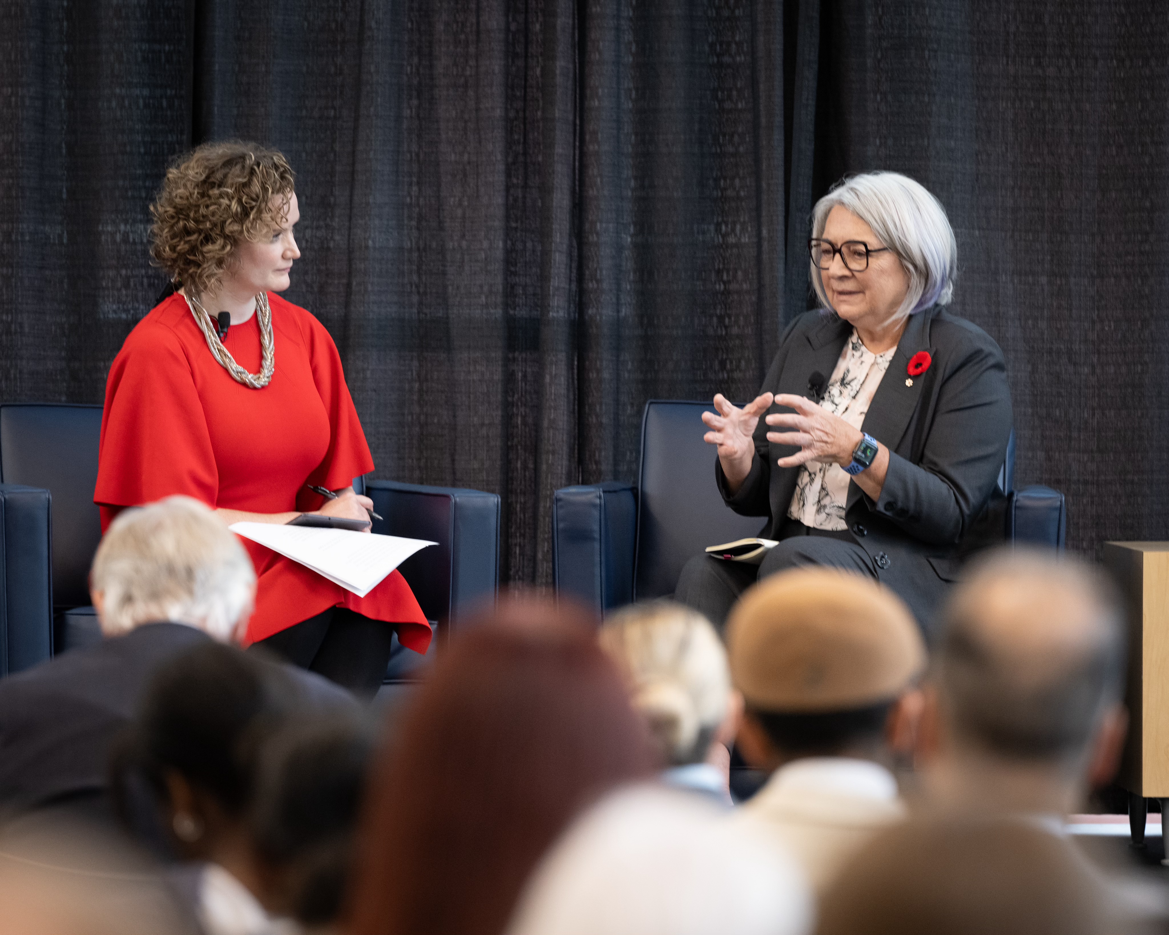 Governor General Mary Simon is seated next to another person on a stage. 