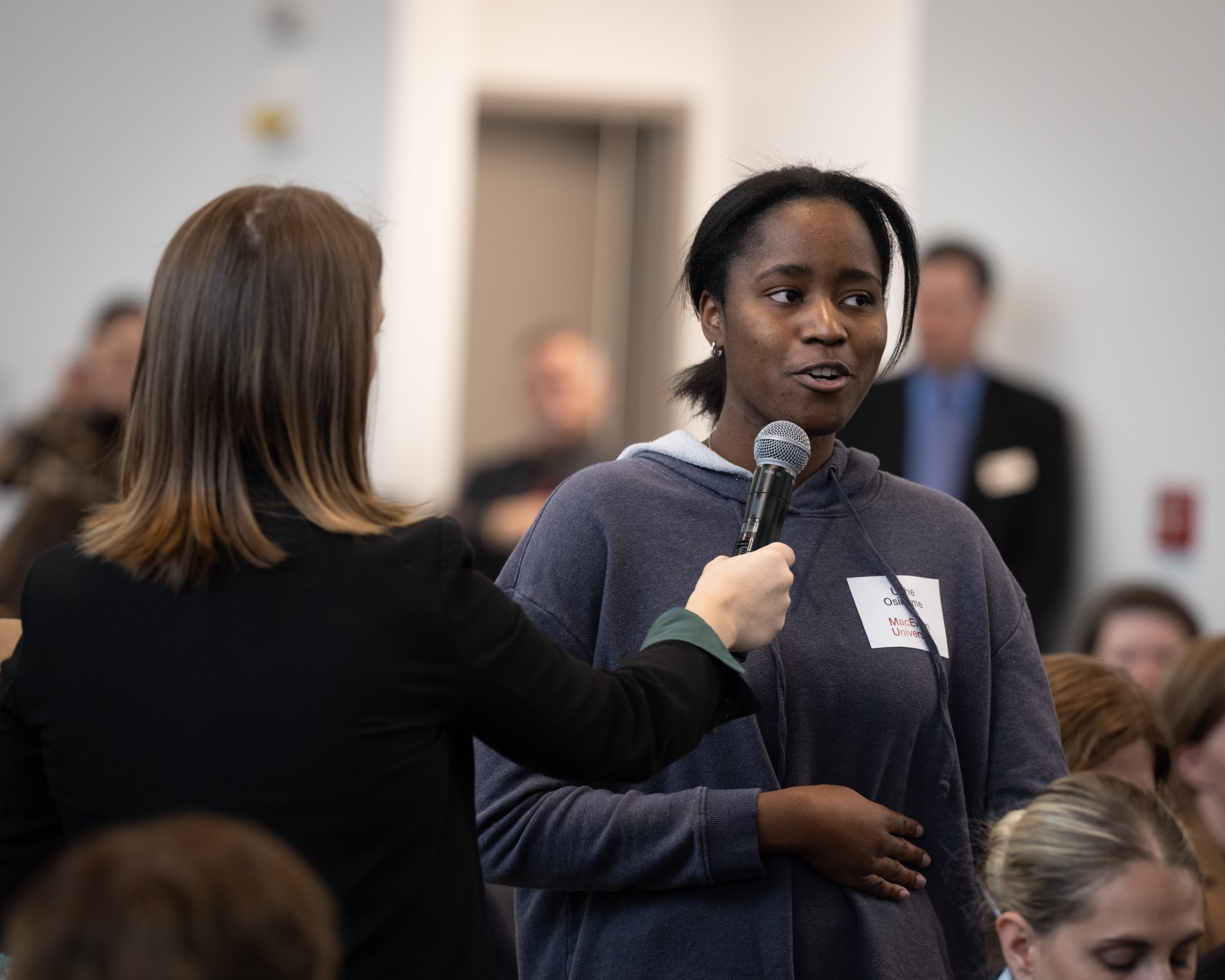 One person speaks into a microphone.