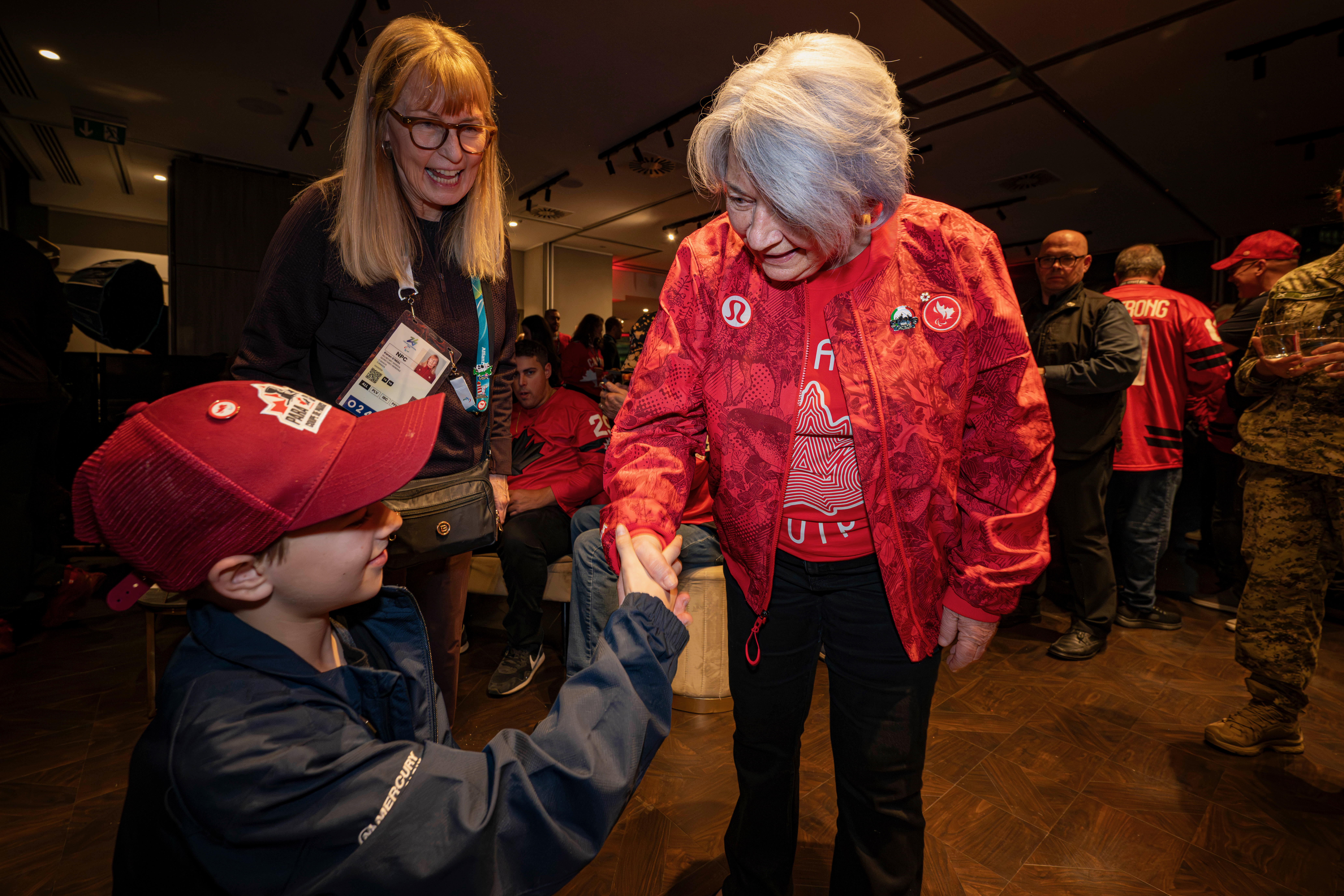 Governor General Mary Simon shaking a person's hand at the event for families and close friends of Canada’s Paralympic athletes watching the opening ceremony on television..