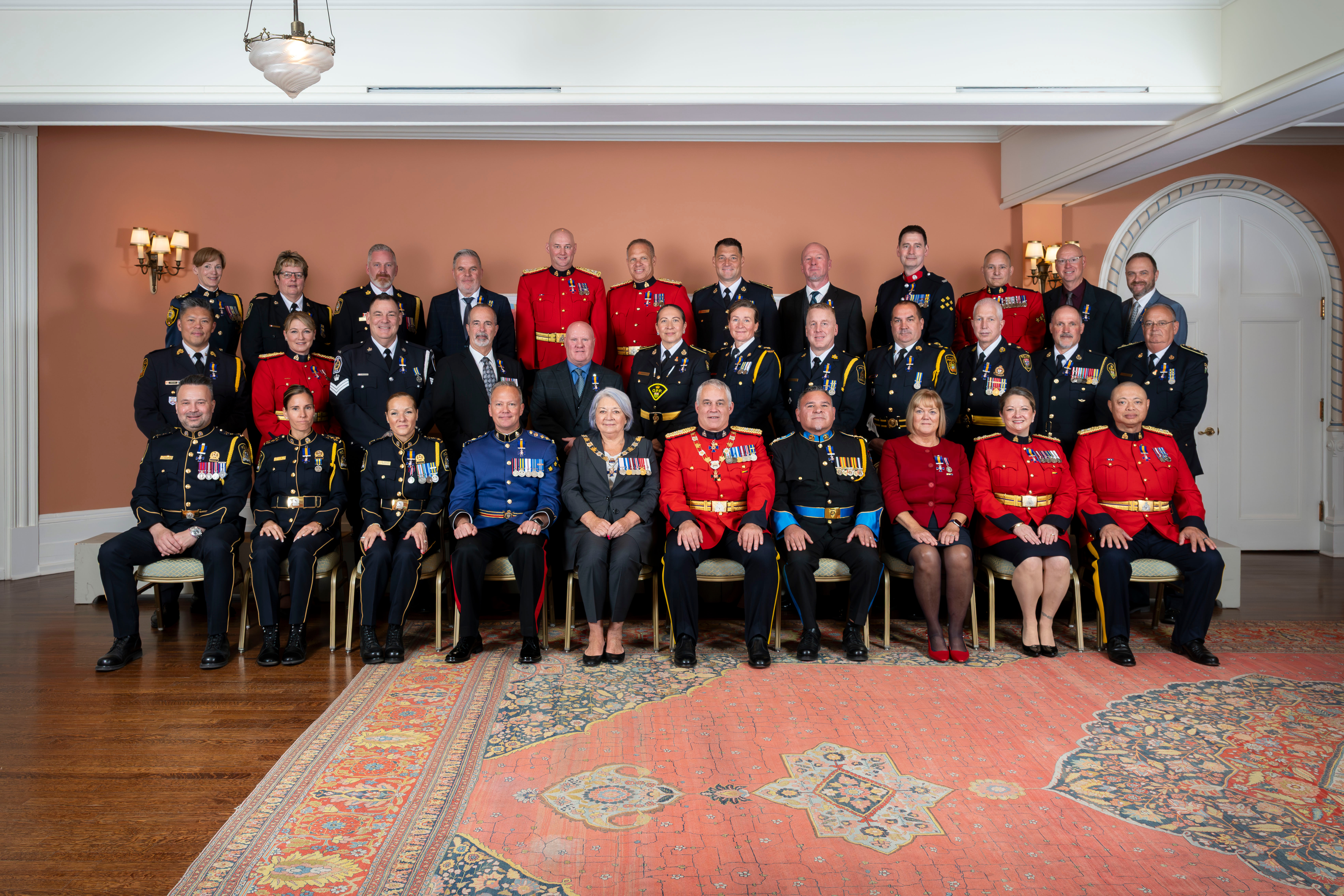 Governor General Mary Simon posing for a group photo with Order of Merit of the Police Forces appointees.