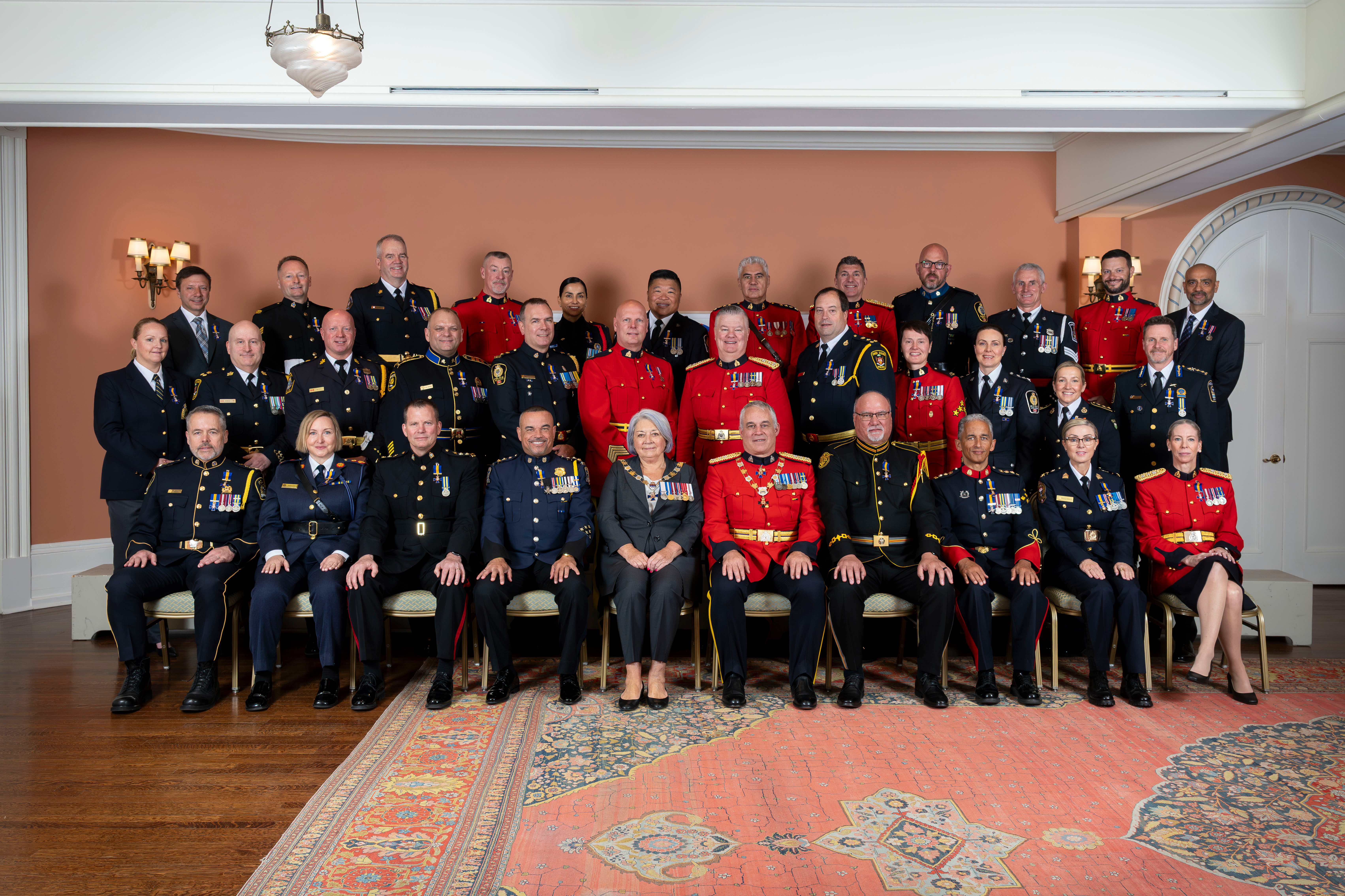 Governor General Mary Simon posing for a group photo with Order of Merit of the Police Forces appointees.
