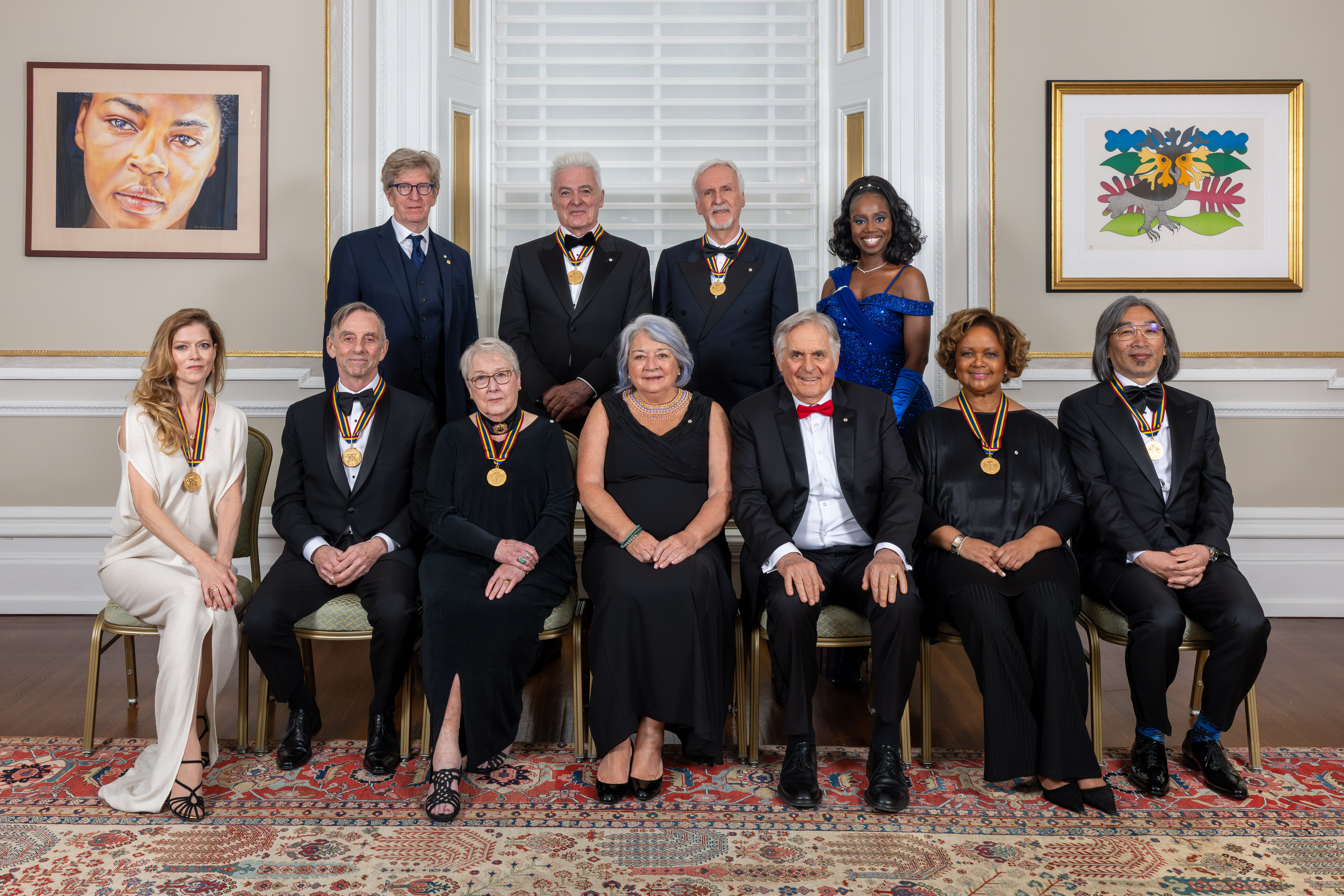 Governor General Mary Simon and Mr. Whit Fraser posing for a photo with Governor General Performing Arts laureates.