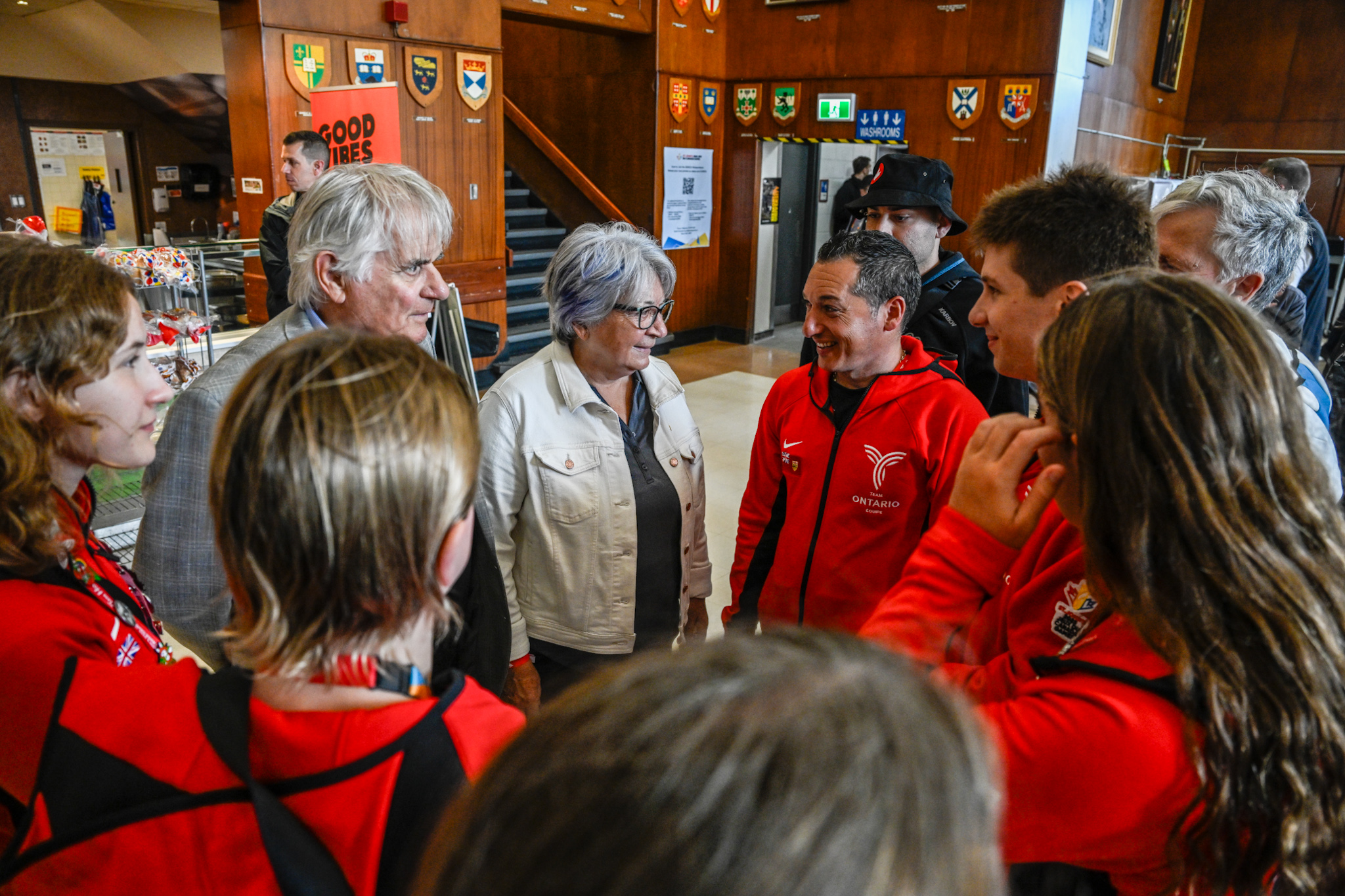 Governor General Mary Simon and Mr. Whit Fraser speaking with a group of people in a lobby.
