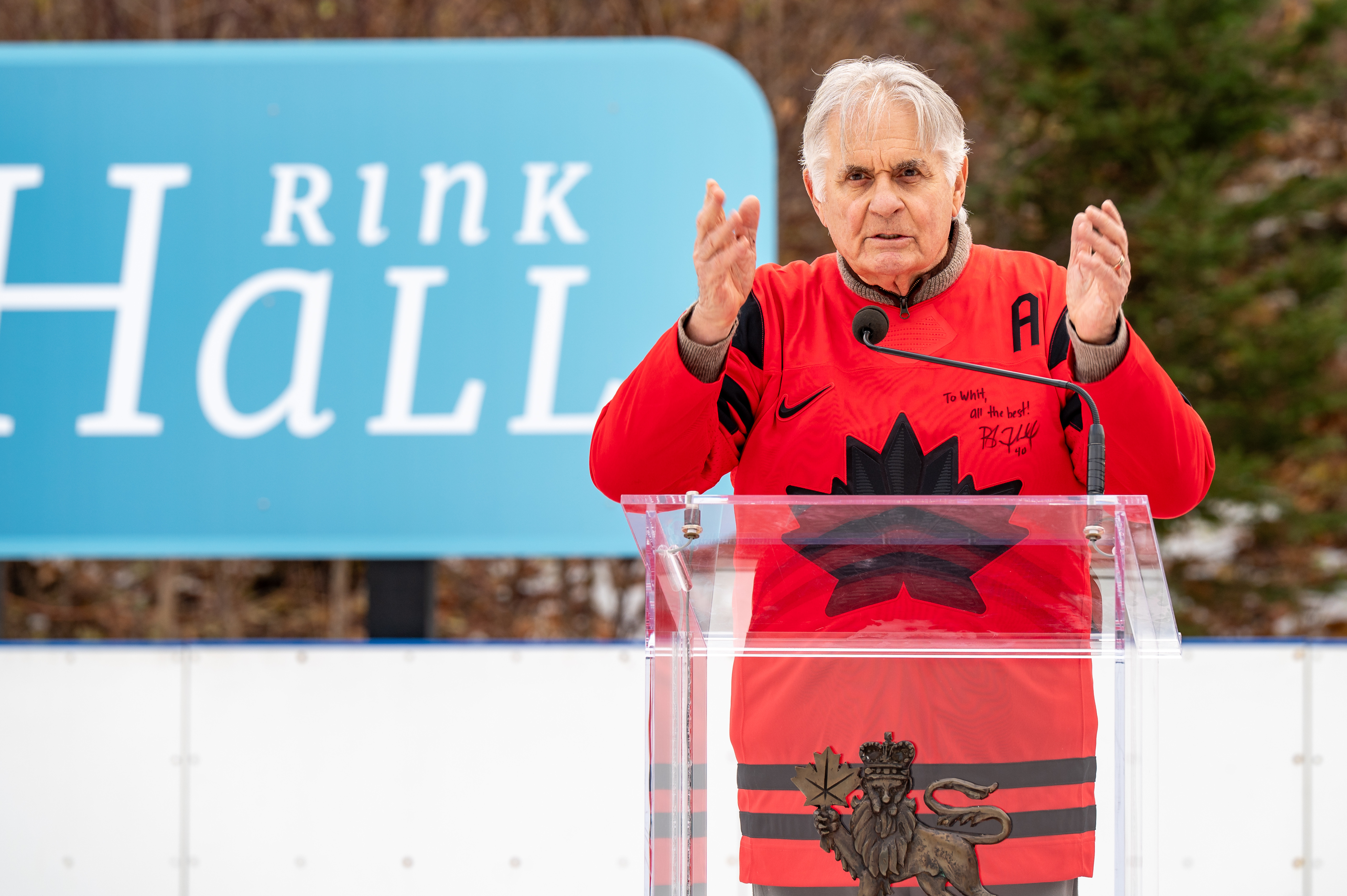 Mr. Whit Fraser standing at a podium on the Rideau Hall Rink.