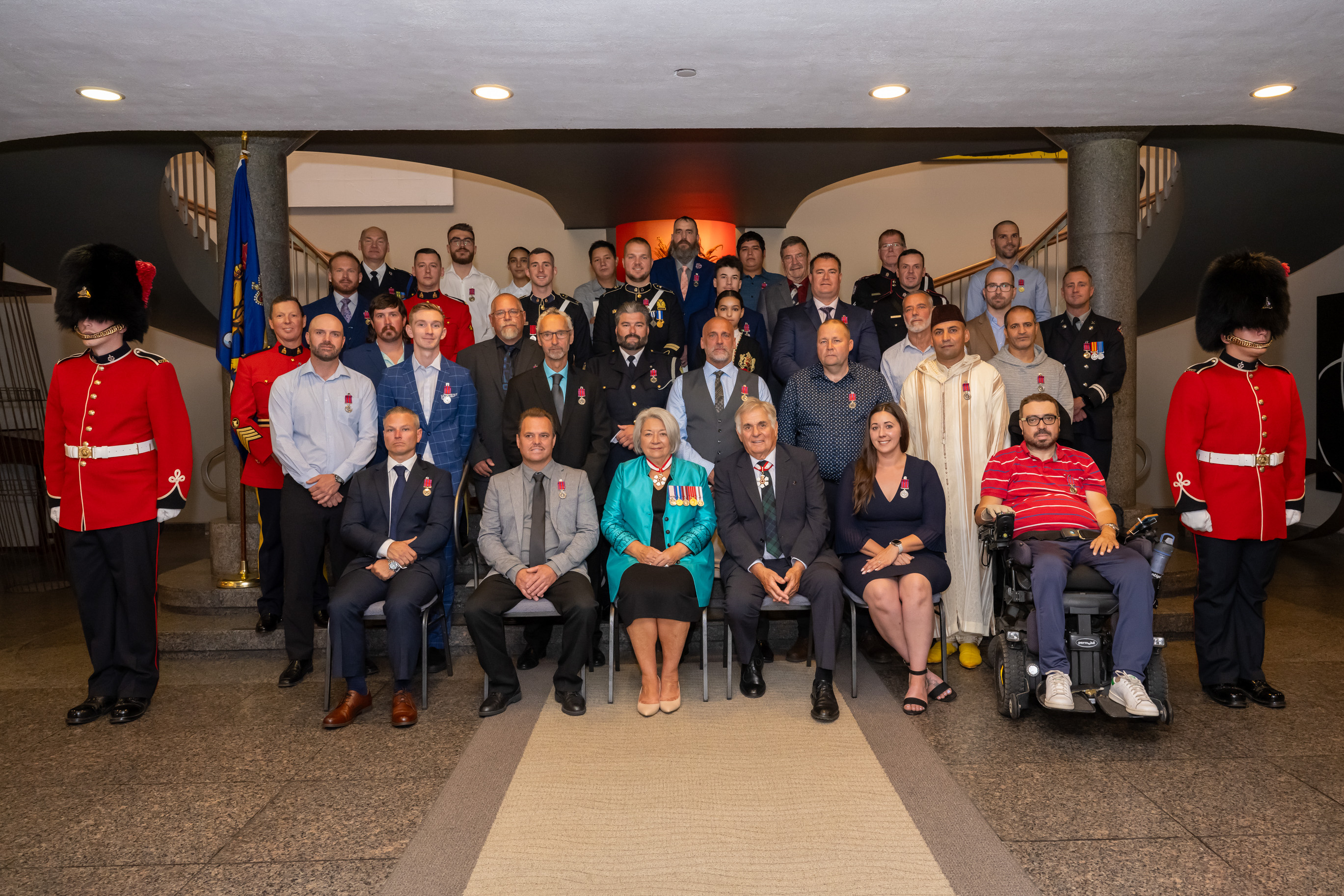 Governor General Mary Simon sits for a group photo with the recipients