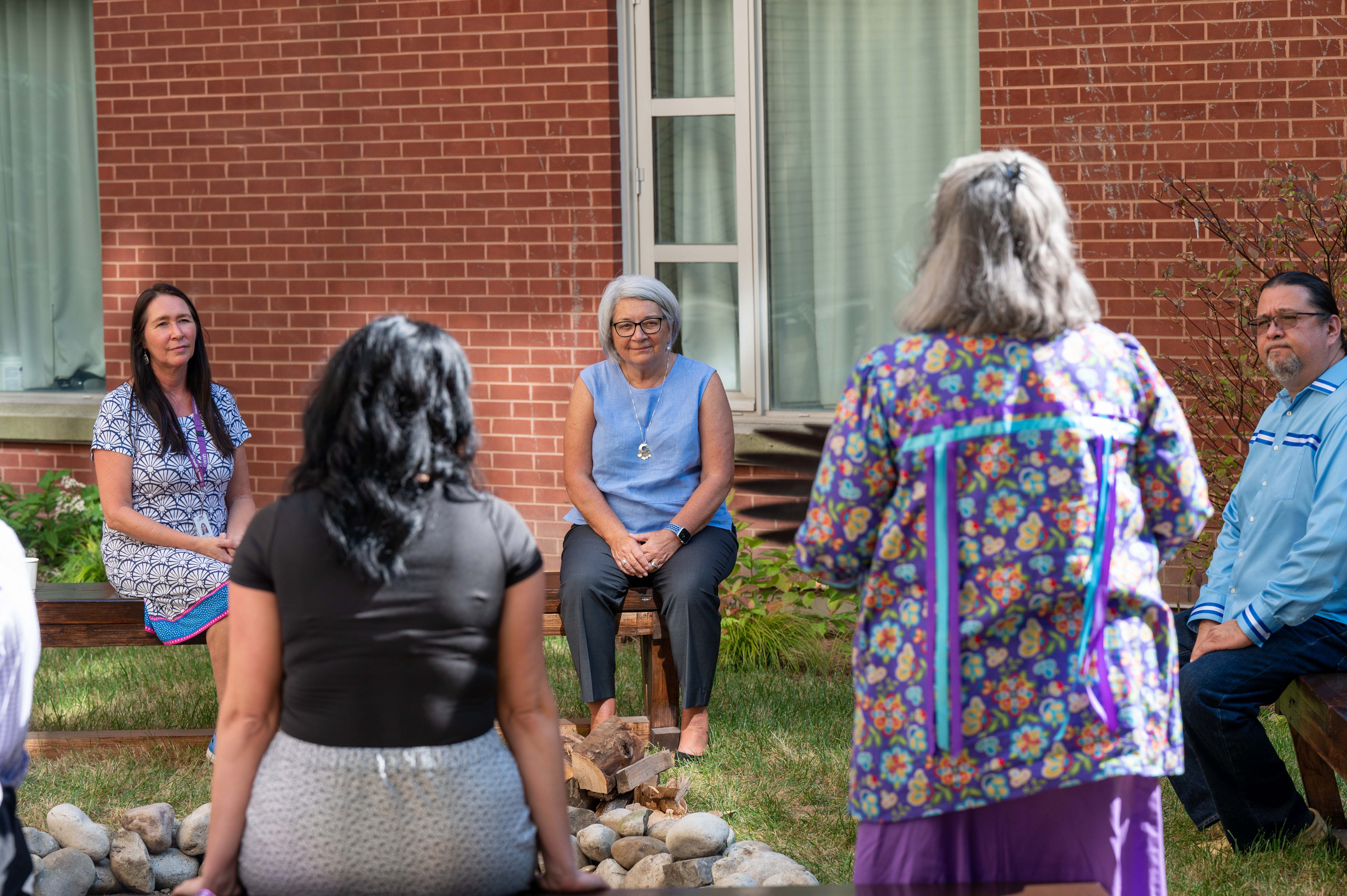 Governor General Mary Simon sits and listens to leaders of the CAMH Shkaabe Makwa program