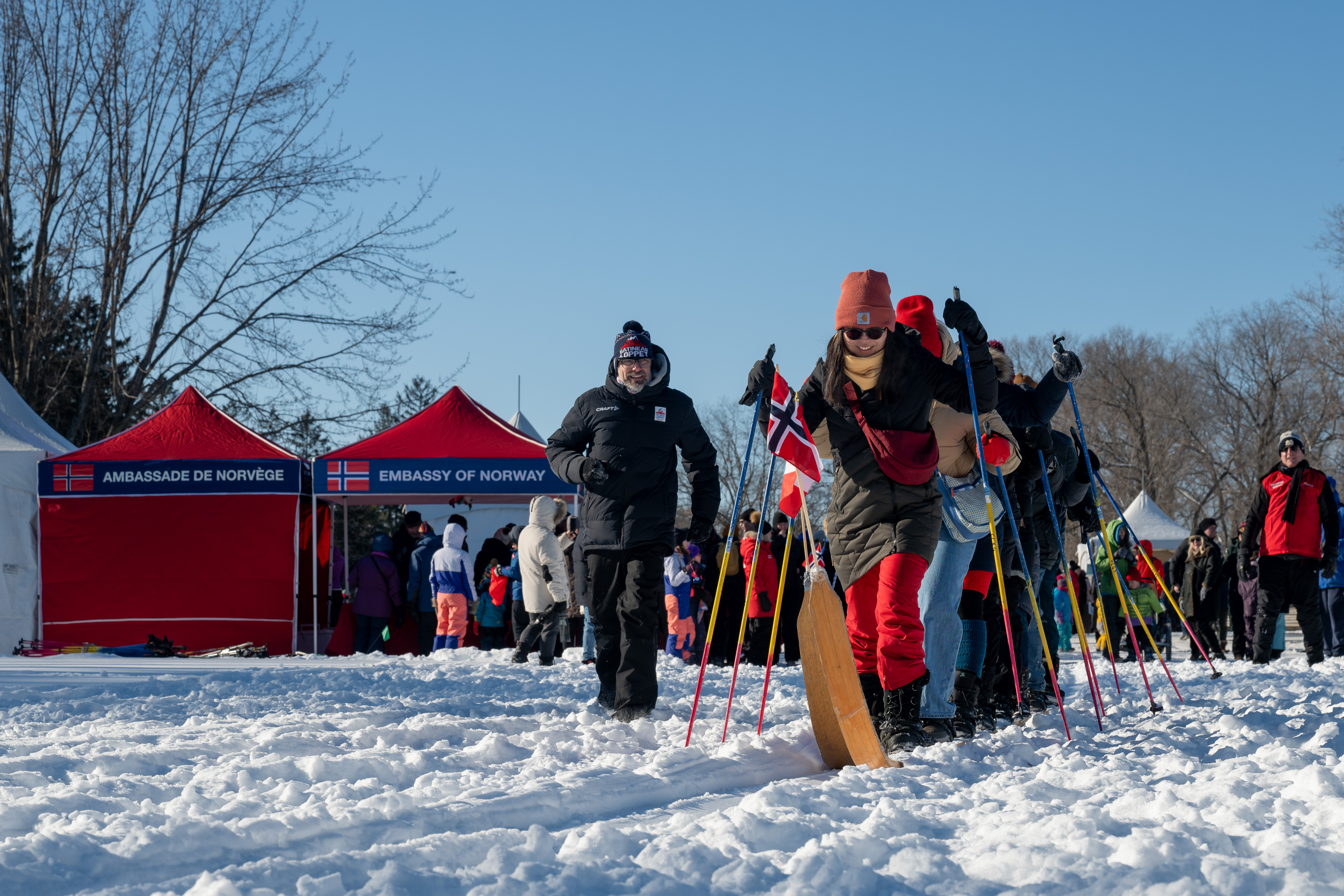 A group of people participating in an outdoor winter activity involving skis and ski poles.