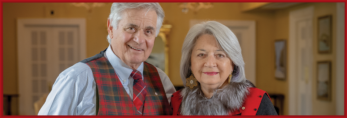 Mr. Whit Fraser and Governor General Mary Simon are standing in the Long Gallery at Rideau Hall.