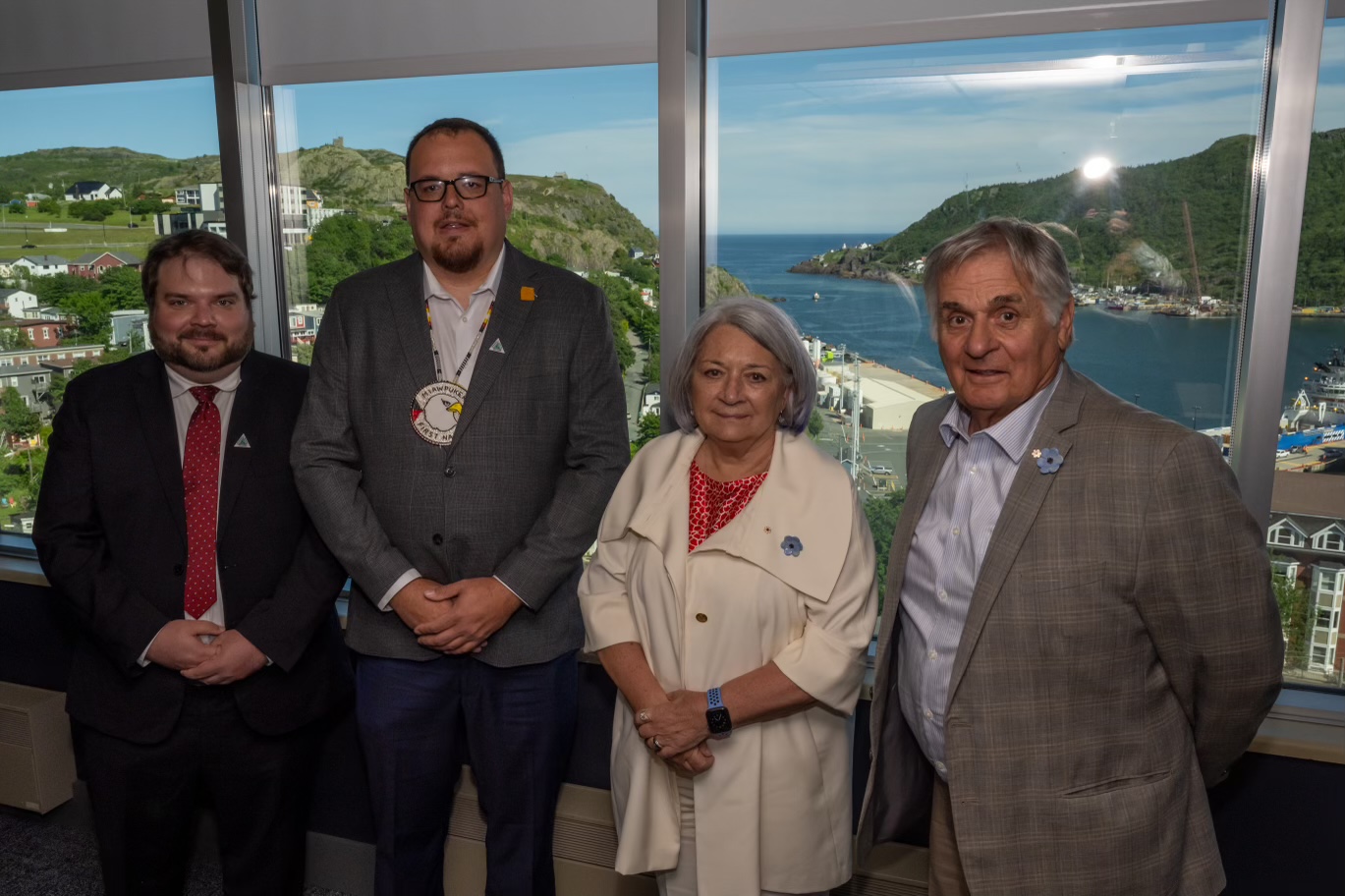 Governor General Simon and Mr. Whit Fraser posing for a photo with Miawpukek First Nation Chief Brad Benoit and another man.