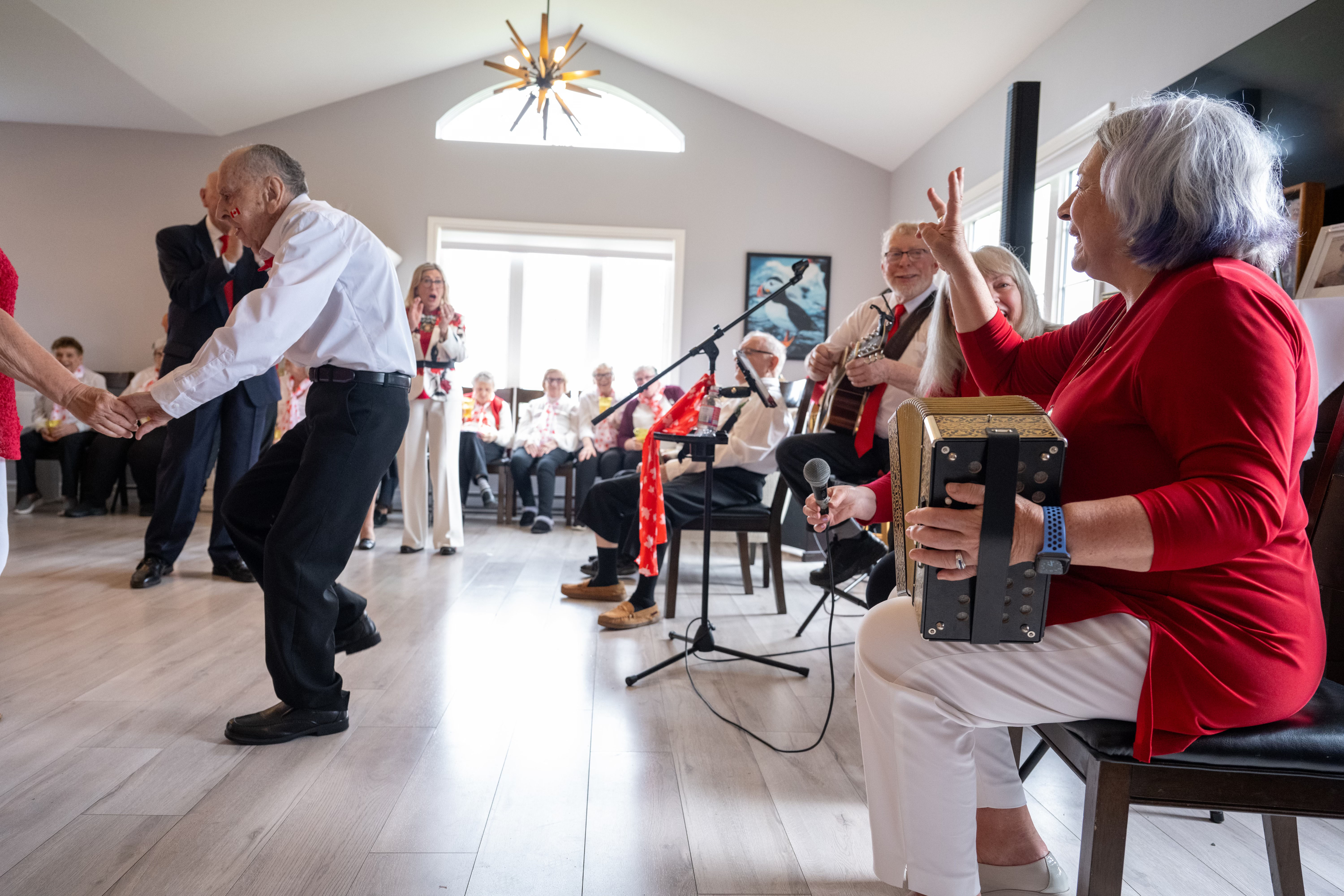 A band playing at a Canada Day celebration at a retirement home. People are dancing. Governor General Simon is playing the accordion.