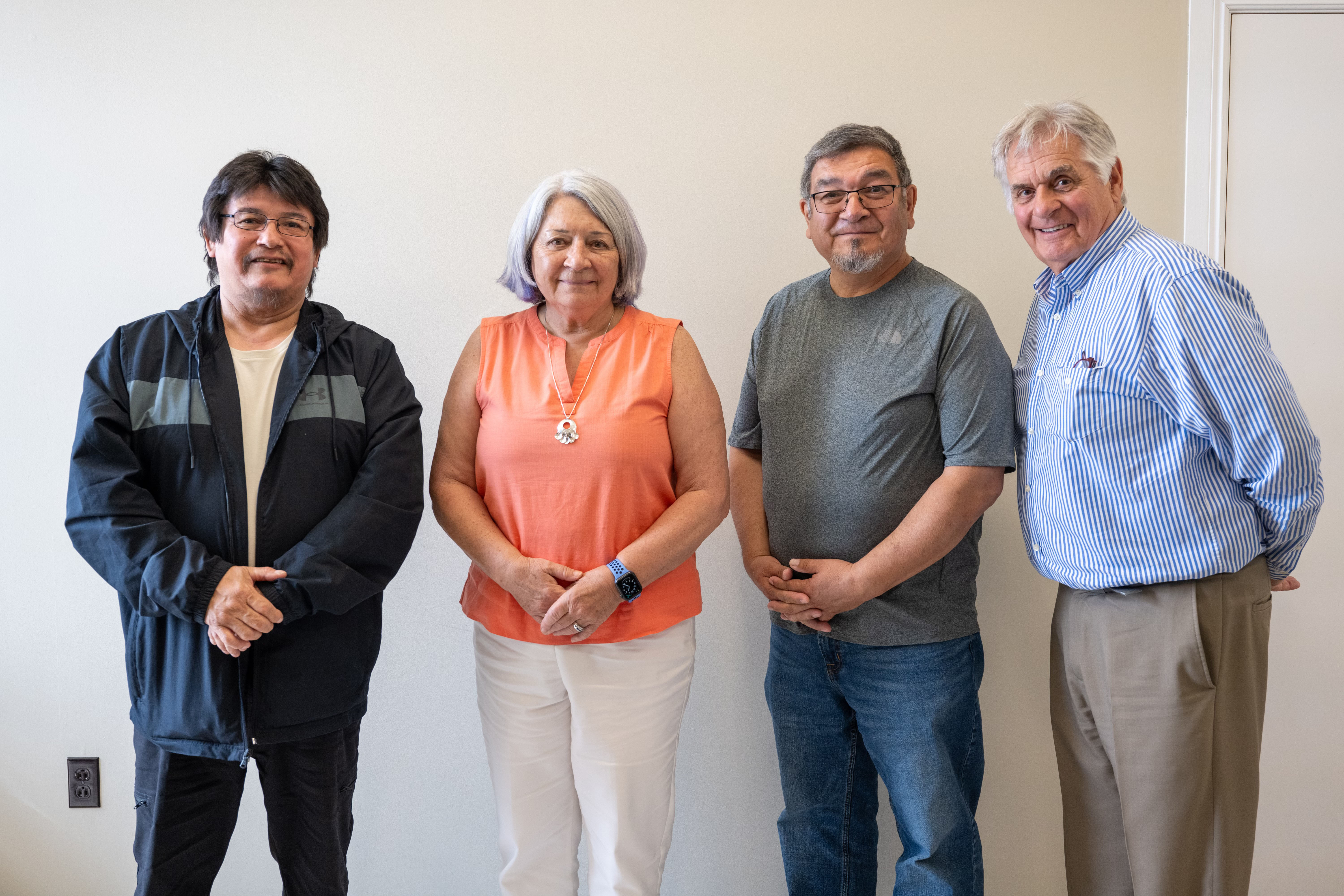 Governor General Mary Simon stands with Grand Chief Simon Pokue of Innu Nation. Mr. Fraser and another man stand next to them.