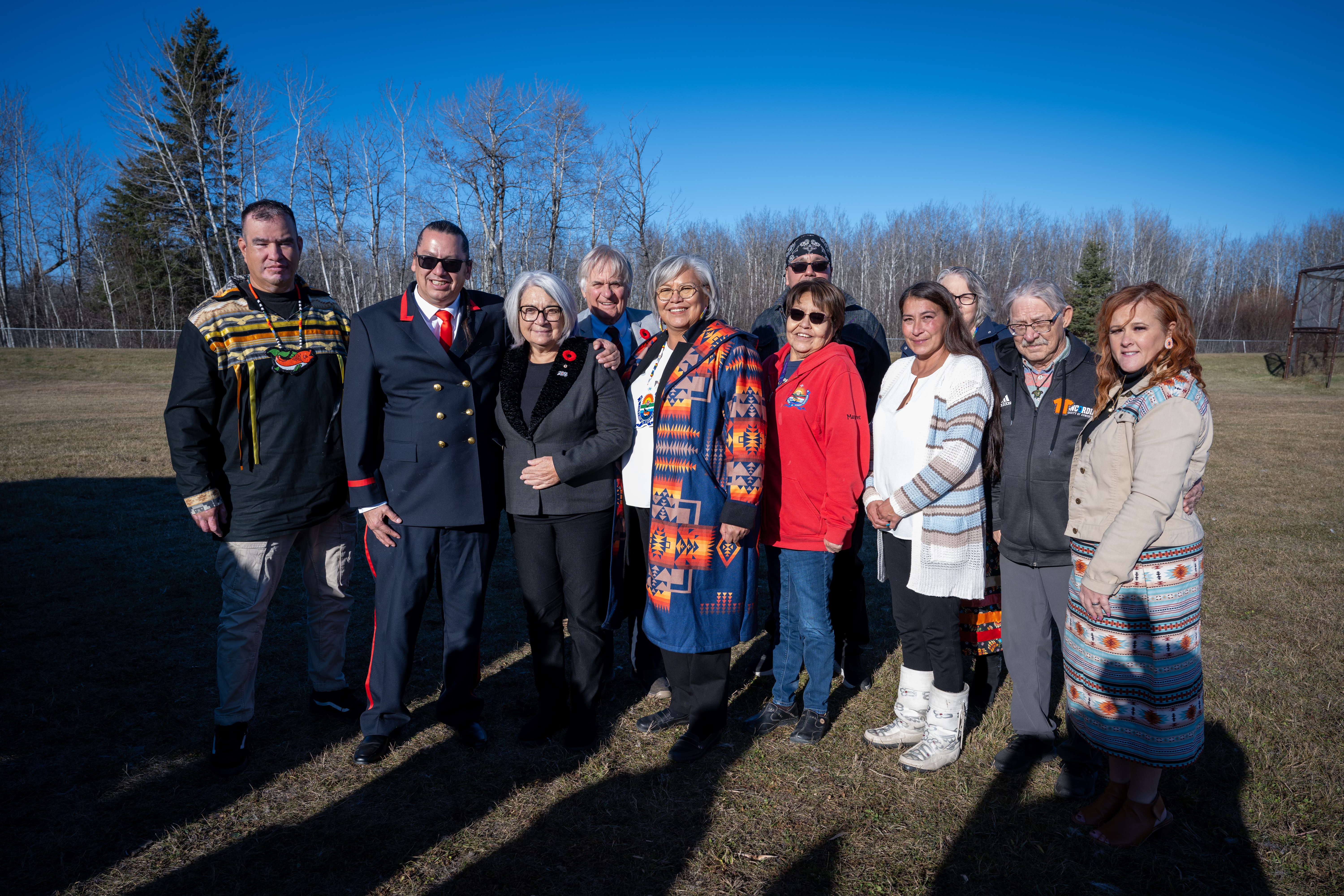 Governor General Mary Simon and Mr. Whit Fraser stand among a group of people.