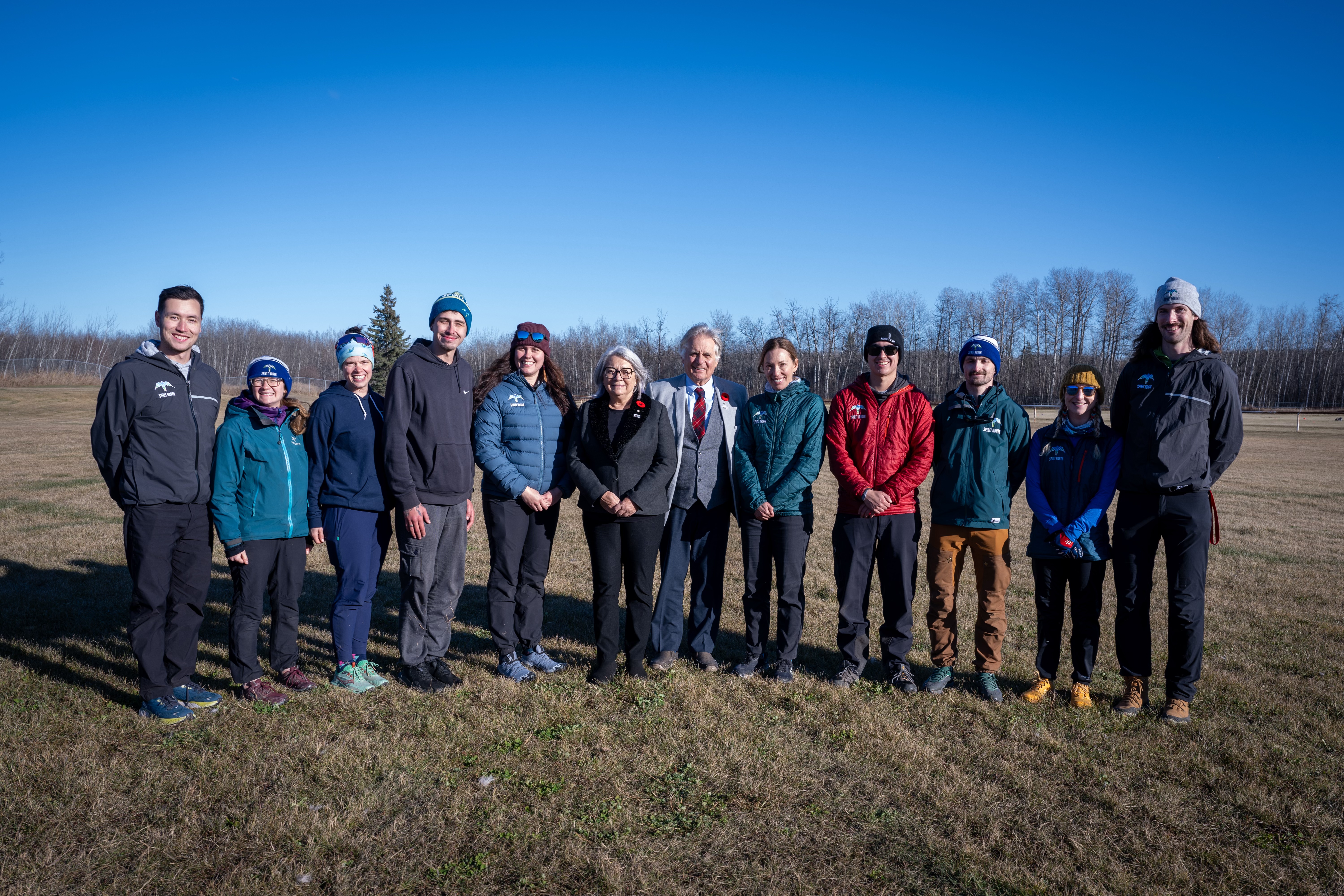 Governor General Mary Simon and Mr. Whit Fraser stand among a group of people.