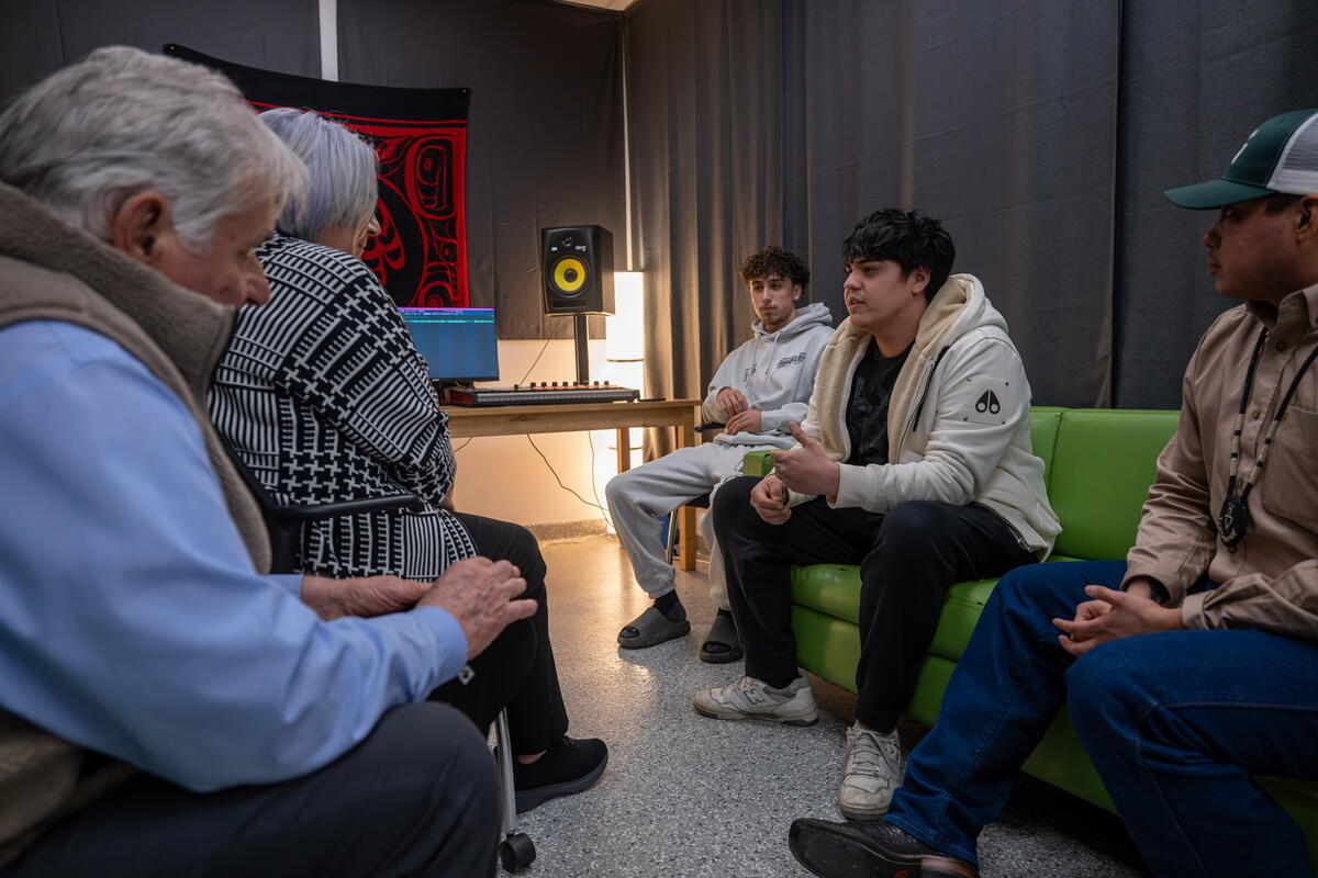 Governor General Mary Simon speaking with young men from the NeXup youth initiative in their music studio.
