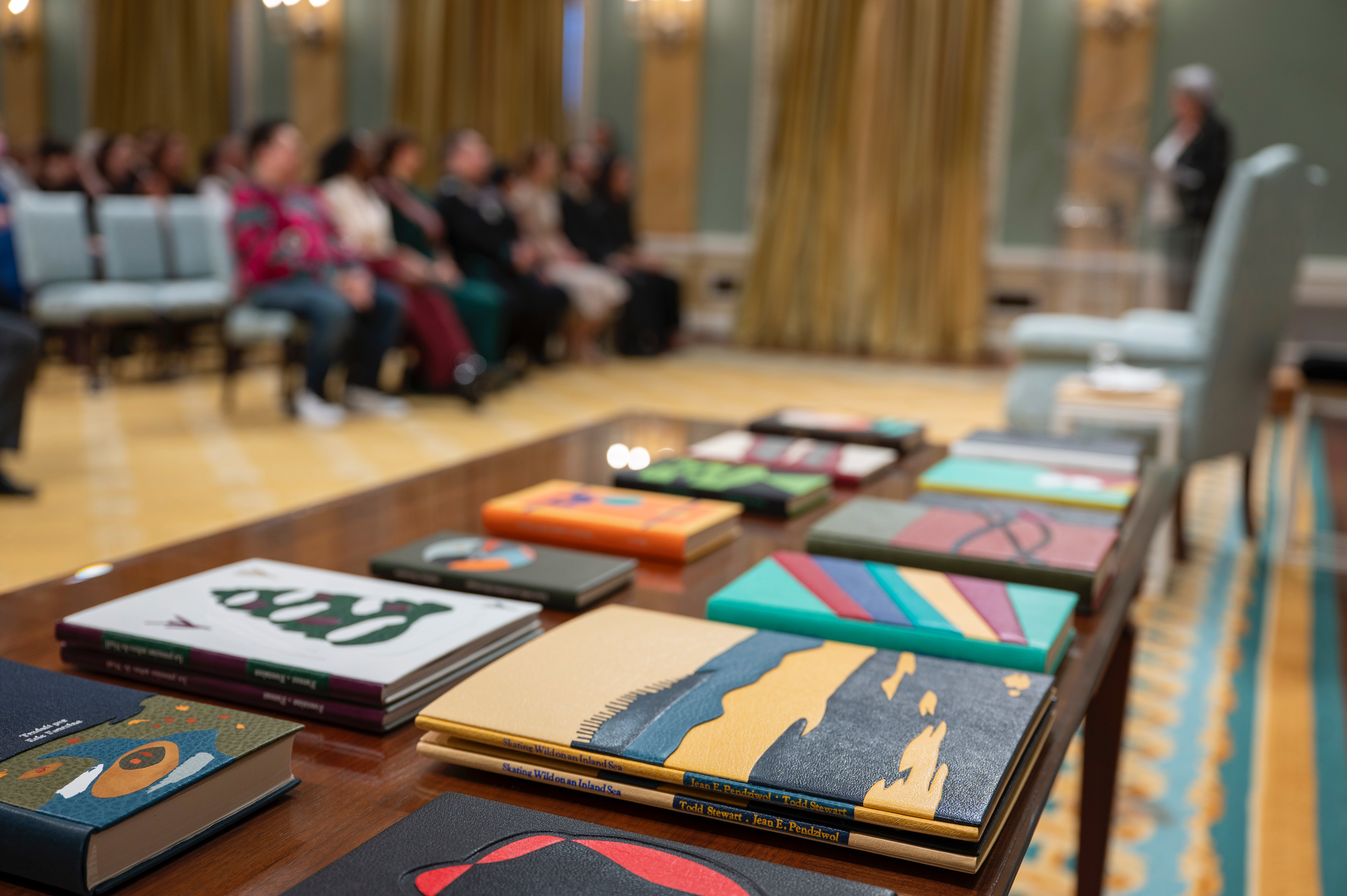 Books on a table. The background is blurred.