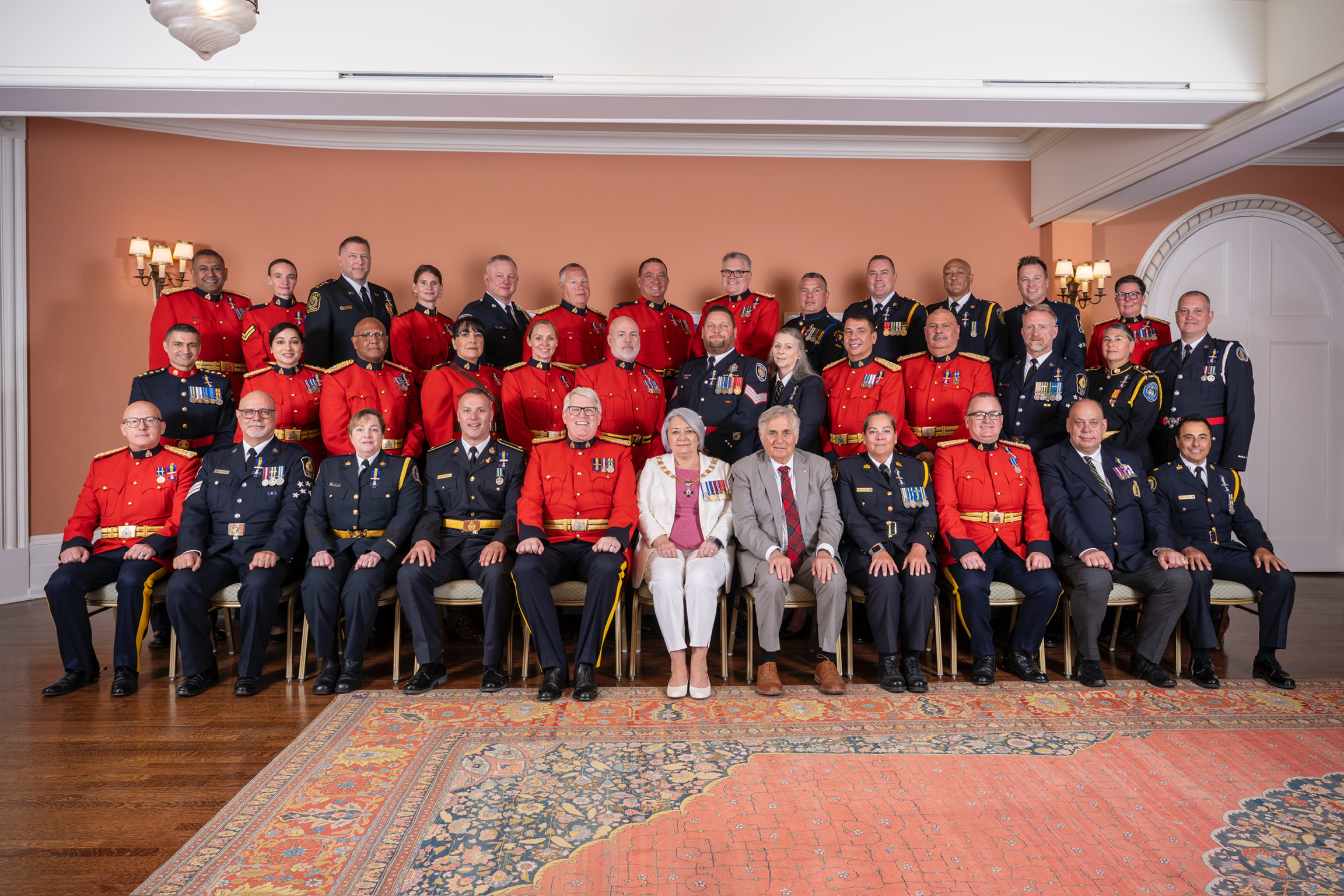La gouverneure générale Mary Simon et M. Whit Fraser avec les récipiendaires de l'Ordre du mérite des forces de police.