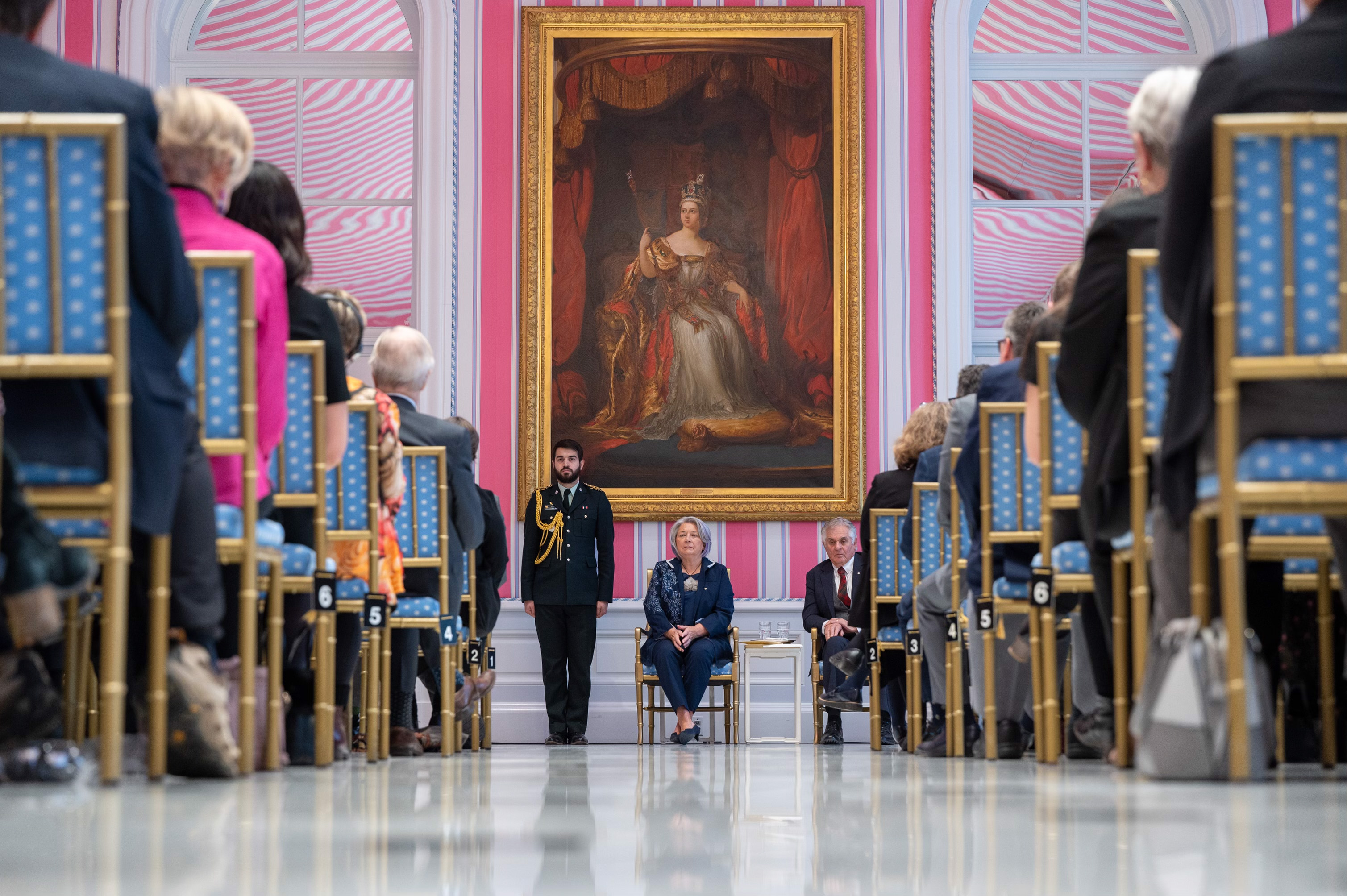 Governor General Mary Simon sits in a chair beside Mr Fraser