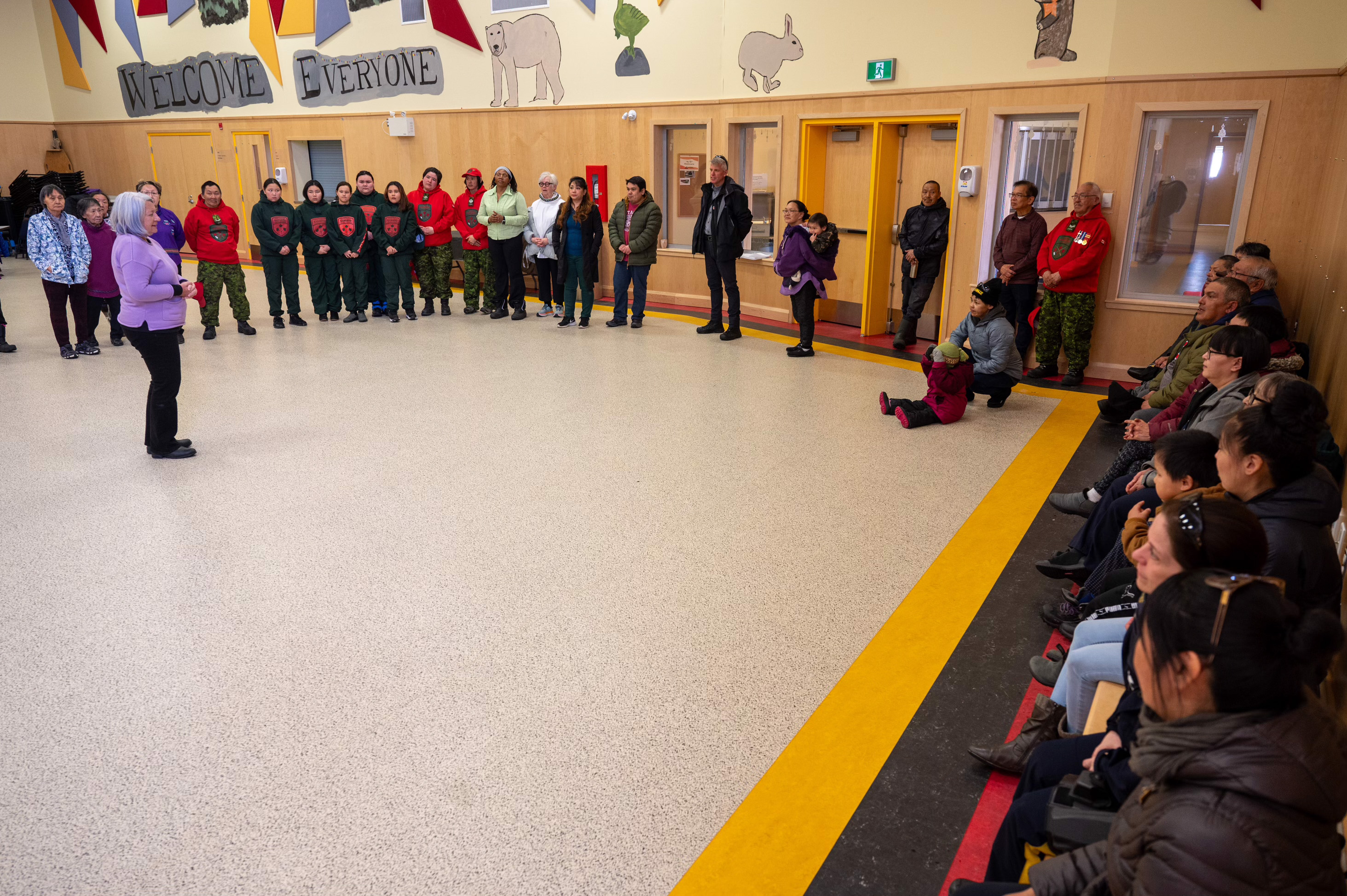 Governor General Mary Simon speaks with the community members who have gathered in a circle.