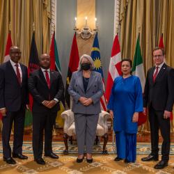 A group photo with Governor General Simon and six new heads of mission, with the flags of each country behind them.