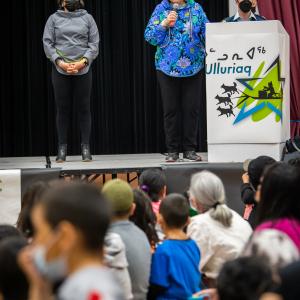 The Governor General is speaking at a podium in a school.