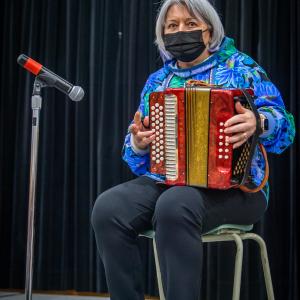 The Governor General is playing the accordion.