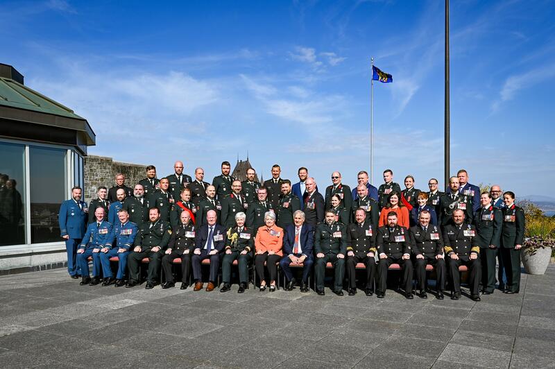 Governor General Mary Simon and Mr. Whit Fraser posing for a photo with honours recipients outside of the Citadelle.