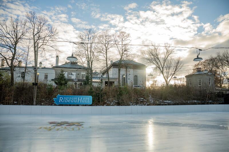 Outdoor skating rink with a blue sign that says 'Patinoire Rideau Hall Rink'.