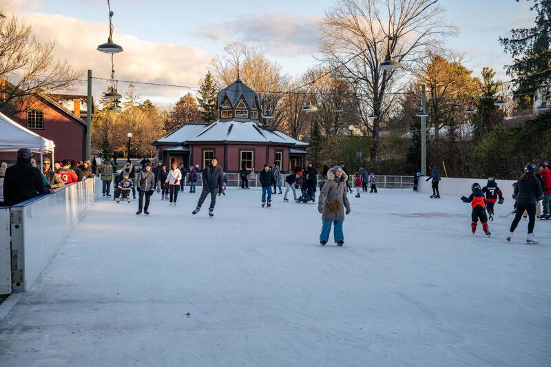 People skating on an outdoor rink.