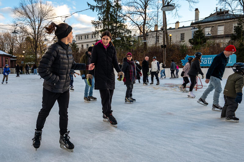 People skating at an outdoor rink.