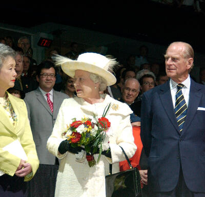 John Ralston Saul, Governor General Clarkson, The Queen and the Duke of Edinburgh stand facing each other, as guests look on from the background.
