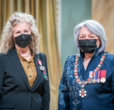 Gertrude Steiger Kearns is standing next to the Governor General.