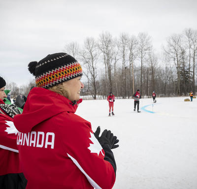 The Governor General cheers on Snowshoeing athletes during a race.