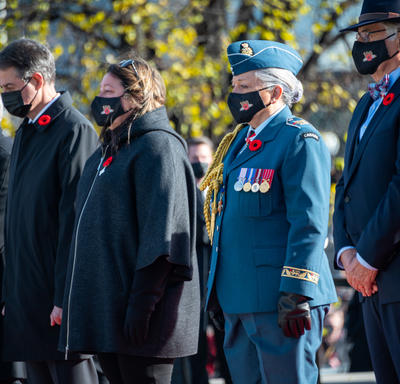 Several people are standing one beside the other outdoors. Mr. Whit Fraser, Governor General Mary Simon, and Ms. Josée Simard (the National Silver Cross Mother) are among them.