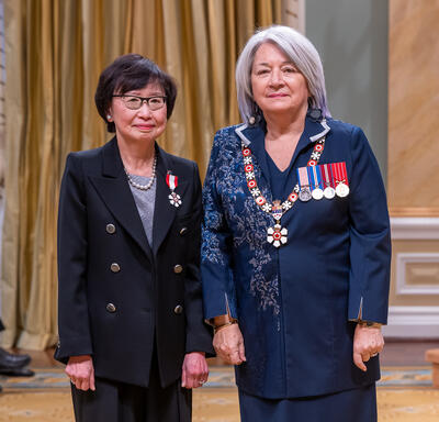 Janice Fukakusa est debout à côté de la gouverneure générale.