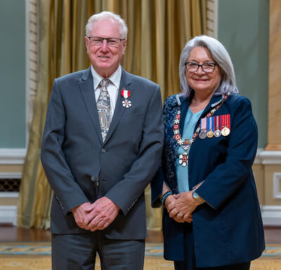 Stefan Glenn Sigurdson is standing next to the Governor General.