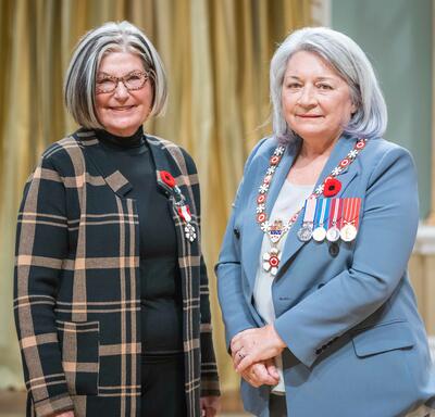 N. Louise Bradley is standing next to the Governor General.