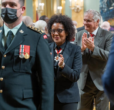 The Right Honourable Michaëlle Jean is clapping as the walks with the procession out of the ballroom.