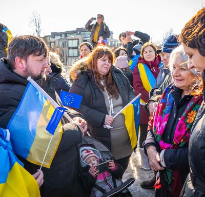 Governor General Simon standing with a group of people. Many of them are holding Ukrainian and European Union flags.