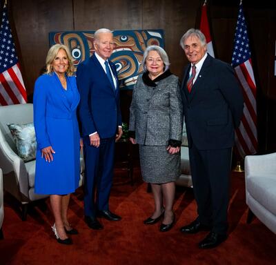 In order from left to right, First Lady Jill Biden, President Joe Biden, Governor General Simon, and Mr. Whit Fraser. They are posing for a group photo. 