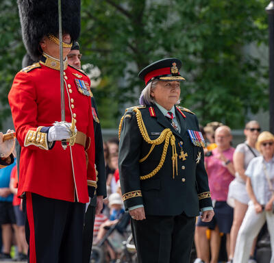 Governor General Mary Simon walks with the Commander of the Ceremonial Guard. She is wearing a Canadian Armed Forces army uniform.