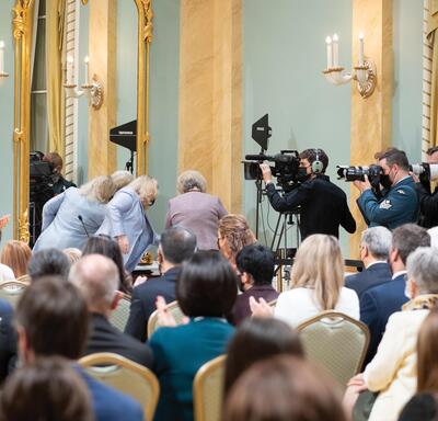 Caméramans et photographes dans la salle de bal lors d’un événement à Rideau Hall.