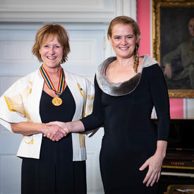 Lorraine Pintal shakes hands with the Governor General.