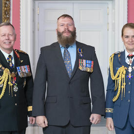  Chief of the Defence Staff of the Canadian Armed Forces General Jonathan Vance and the Governor General pose with Master Warrant Officer Cordell James Herman Boland, M.M.M., C.D.