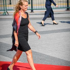 La gouverneure générale marche sur un tapis rouge en direction de son siège lors de la cérémonie commémorative.