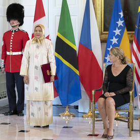 Her Excellency Nor’aini Binti Abd Hamid, High Commissioner for Malaysia, stands beside the Governor General. 